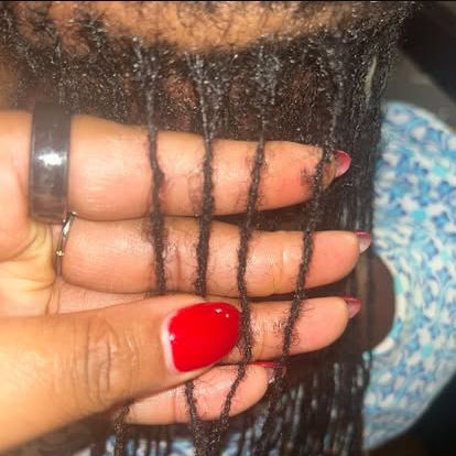 Small loc strands held apart during a close-up assessment