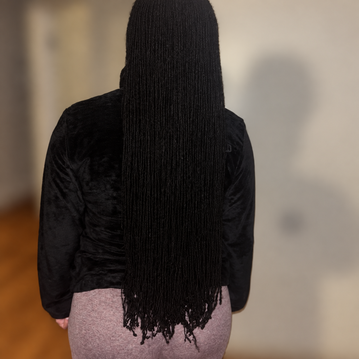 Long microlocs photographed from behind; no face visible